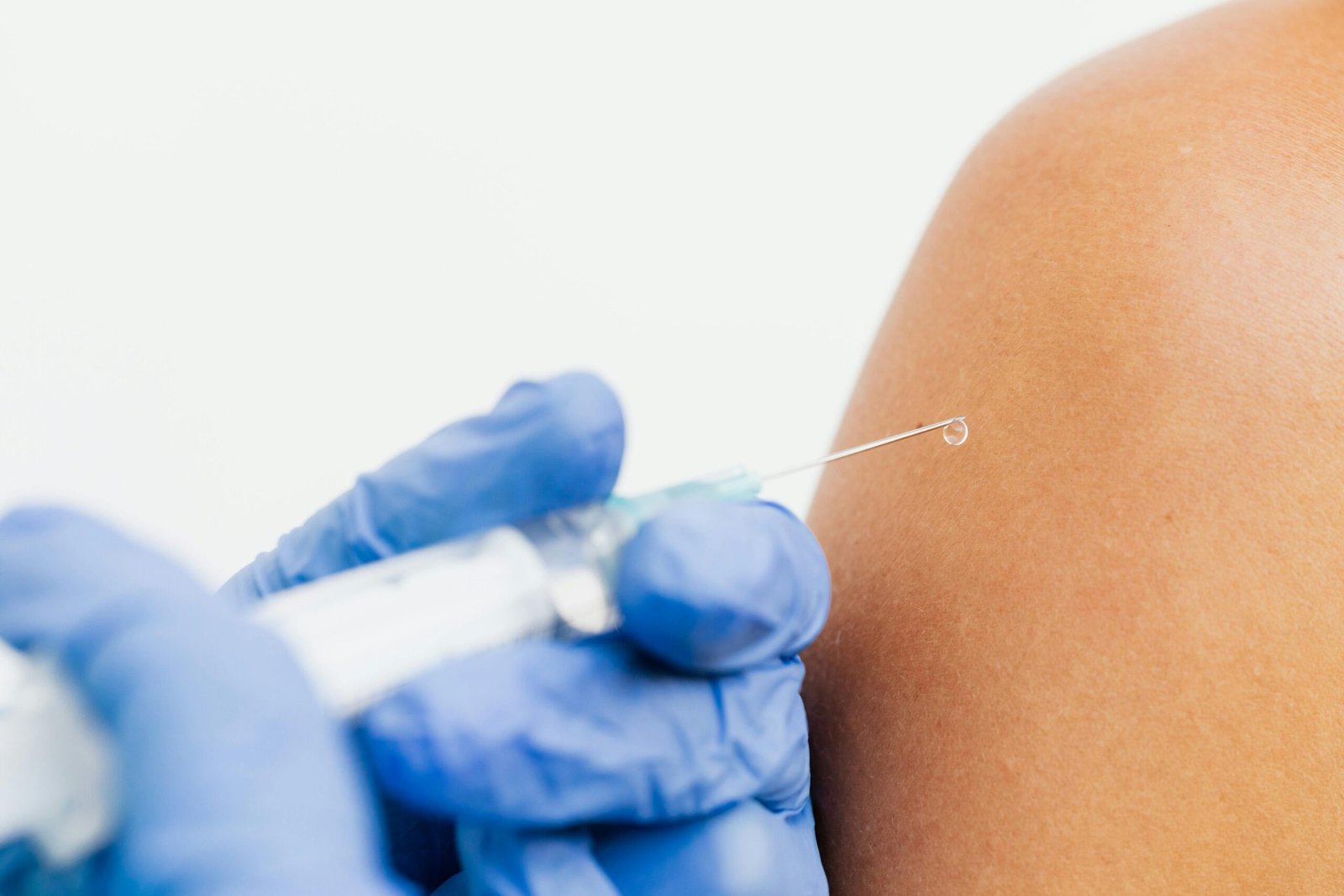 Close-up of a healthcare professional administering a vaccine.