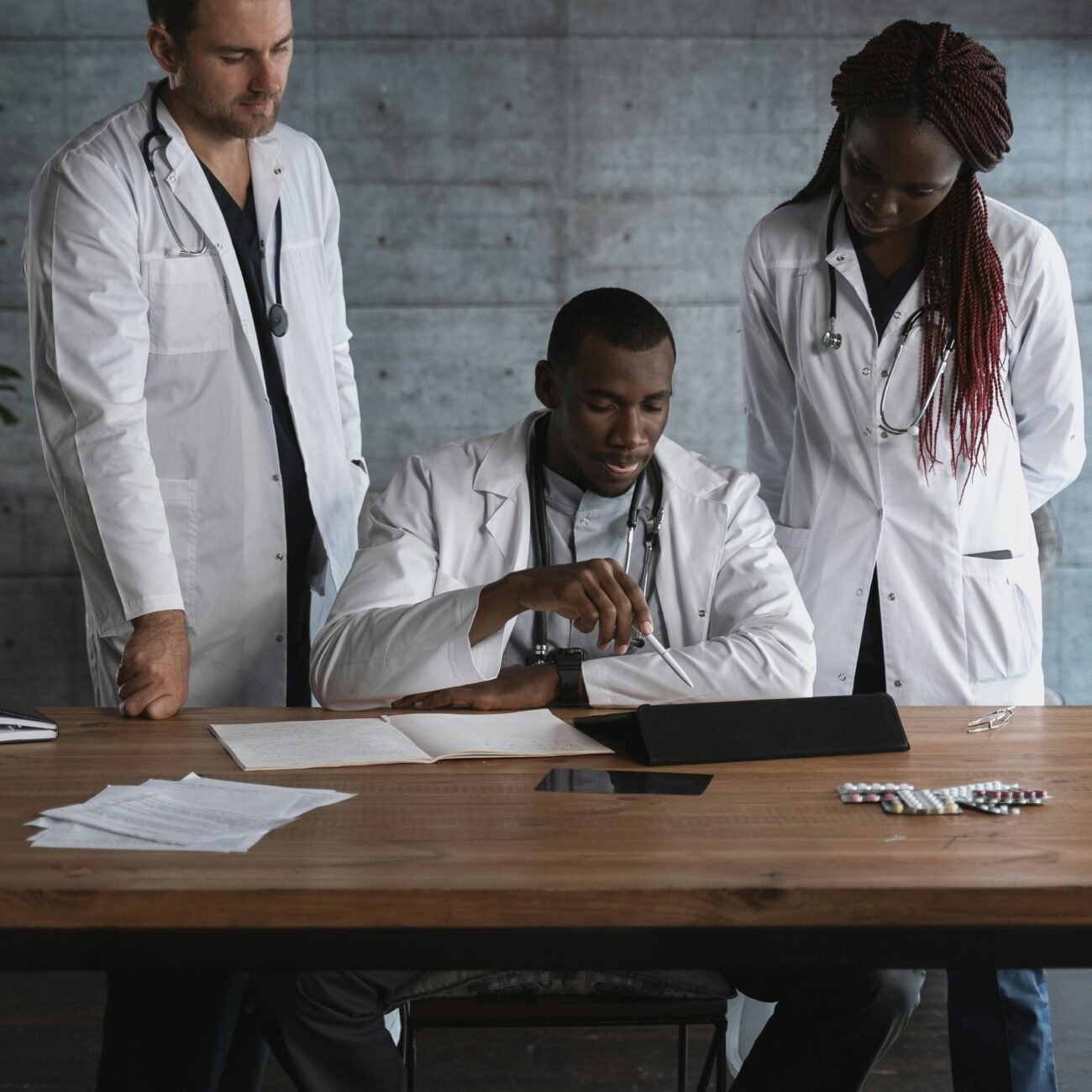 A team of diverse doctors collaborating on medical research in a modern workspace.